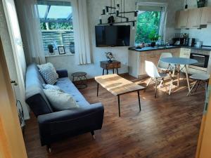 a living room with a couch and a table at Meerhuuske Käthe in Südbrookmerland