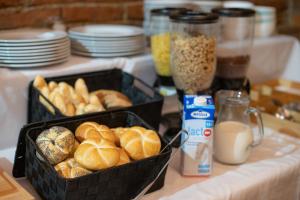 two baskets of bread and milk on a counter at Mikulov Inn - Apartments Slunce in Mikulov