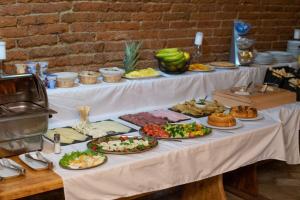 a table with many plates of food on it at Mikulov Inn - Apartments Slunce in Mikulov