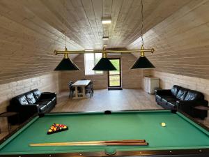 a room with a pool table in a house at Guest house Elernes Muiža in Daugavpils