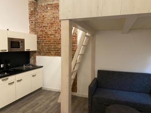 a room with a loft bed and a kitchen at Stuck Ferienwohnungen in Cottbus