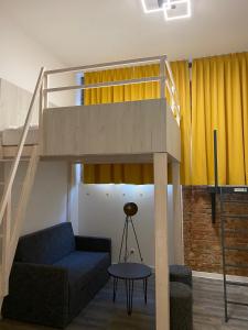 a living room with a loft bed and a couch at Stuck Ferienwohnungen in Cottbus