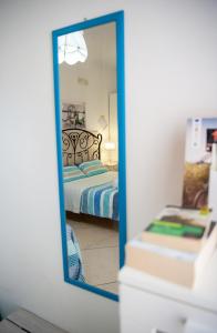 - un miroir dans une chambre avec un lit dans la réflexion dans l'établissement Vacanze al San Domenico, à Mola di Bari