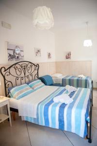a bedroom with a bed with blue and white stripes at Vacanze al San Domenico in Mola di Bari