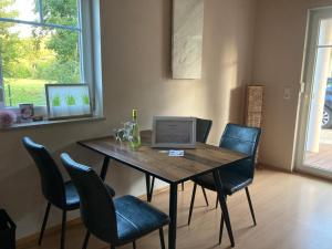 a dining room table with a laptop computer on it at Villa Toskana Wohnung 1 in Wackersdorf