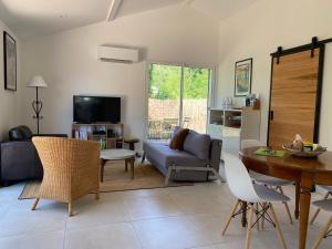 a living room with a couch and a table at La Petite Caserne - Gite 4 étoiles - in Pont-de-Labeaume