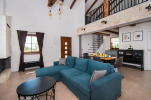 a living room with a blue couch and a table at Villa Lucia in Skradin