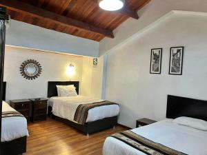Postel nebo postele na pokoji v ubytování Hostal Casona Arrambide