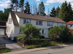 a white house with a brown roof at Haus Waldblick in Hohegeiß