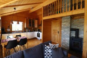 a living room with a blue couch and a kitchen at Golden Circle Vacation Home with hot tub & fire place in Selfoss