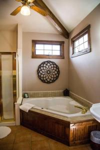 a bathroom with a large tub and a sink at Sundance Suite, 1 Bedroom with fireplace Dogs OK in Estes Park