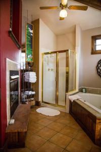 a bathroom with a shower and a bath tub at Sundance Suite, 1 Bedroom with fireplace Dogs OK in Estes Park