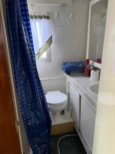 a small bathroom with a toilet and a sink at Hills Motel & Marina in Alexandria Bay