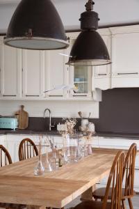 a kitchen with a wooden table with chairs at Villa Aiolos: above the sea, within Agios Nikolaos in Agios Nikolaos