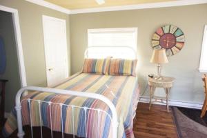 エステス・パークにあるMt Olympus Cabin, Cozy 1 bedroom cabin Great for couplesのベッドルーム1室(ベッド1台、壁掛け時計付)