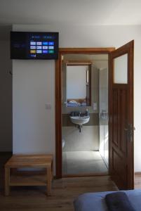 a bathroom with a sink and a glass door at Willa Cisyna in Gliczarów