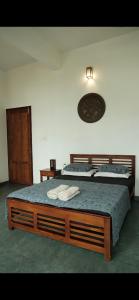 a bedroom with two beds and a dresser in it at Neela Waters - Beach Home in Alleppey