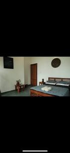 a room with two beds and a wooden door at Neela Waters - Beach Home in Alleppey
