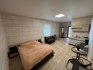 a bedroom with a large bed and a desk at Guest house Elernes Muiža in Daugavpils +182 photos