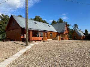 a large wooden barn with a metal roof at Guest house Elernes Muiža in Daugavpils