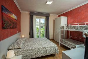 a bedroom with two bunk beds and a window at B&B Carmelina in Gragnano