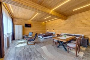 a room with a bed and a table and chairs at Вила Морава in Pamporovo