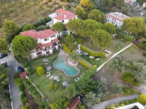 an aerial view of a house with a yard with a pool at Villa Xanthippi in Agia Paraskevi
