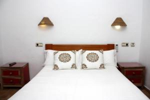 Posteľ alebo postele v izbe v ubytovaní Hostal Extramuros
