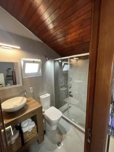 a bathroom with a toilet and a sink and a shower at Sea View Loft in Koskinou