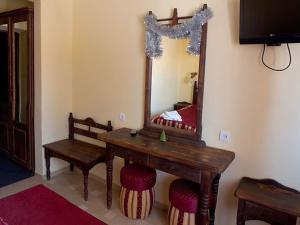 a room with a mirror and a wooden table and stool at 100 metriv vid vytyagu in Bukovel