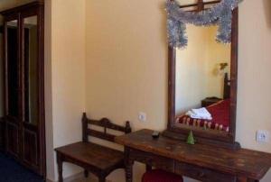 a room with a mirror and a table and a bench at 100 metriv vid vytyagu in Bukovel