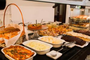 a buffet table filled with different types of food at Hotel San Juan Johnscher in Curitiba