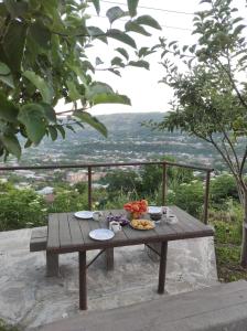 a picnic table with food on it with a view at NAREK B&B in Goris