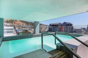 uma varanda com uma piscina no topo de um edifício em Backup-Powered Trendy NY City Apartment at Table Mountain em Cidade do Cabo
