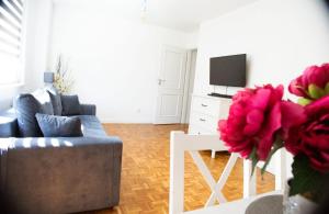 a living room with a couch and a tv at Apartament Jaśminowy in Gdańsk