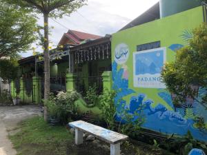 a building with a bench in front of it at Padang Homestay in Padang