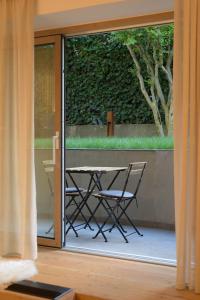 a table and chairs outside a sliding glass door at CityChalet romantic Bozen in Bolzano