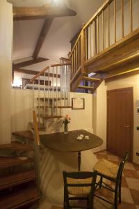 a dining room with a table and a staircase at Agriturismo Il Bove in Reggio Emilia