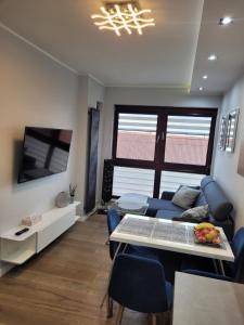 ein Wohnzimmer mit einem Sofa und einem TV in der Unterkunft Apartament Chmielna - Waterlane Island in Danzig