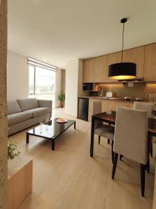 a living room with a couch and a table at Onkel Inn Apart Suites in La Paz