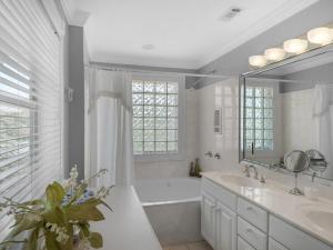a white bathroom with a tub and a sink at It Had to Be You by Newman-Dailey in Destin
