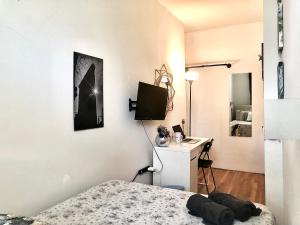 a bedroom with a bed and a desk and a television at Manhattan -UES - Room Accommodation in New York