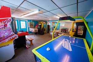 a room with a pool table and arcade games at Moody Beach Camping Resort 28 ft. Park Model 6 in Moody