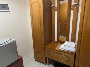 a bathroom with a wooden cabinet and a mirror at Hotel Belvedere in Pogradec