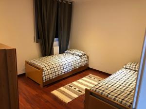 Voodi või voodid majutusasutuse Cozy Apartment Barzio toas