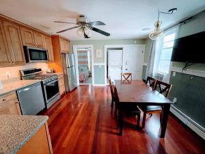 a kitchen with a wooden table and a dining room at Luxury Executive Suite Harvard Allston 3 Bedrooms 2 Baths in Boston