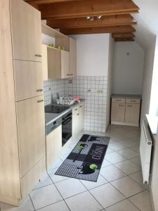 a kitchen with a floor mat on the floor at Ferienwohnung Haus Maja in Holzkirchen