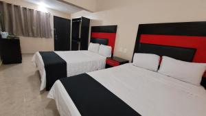 Cama ou camas em um quarto em Hotel Jardín Cancún