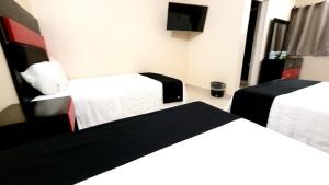 Cama ou camas em um quarto em Hotel Jardín Cancún