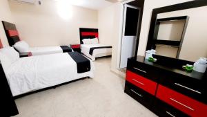 Cama ou camas em um quarto em Hotel Jardín Cancún